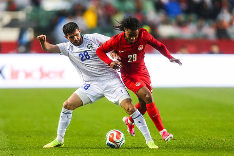 Canada's Jayden Nelson (29) battles against Uzbekistan's Aziz Amonov (28) during the second half of an international friendly soccer match in Edmonton, Alberta.