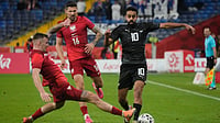 | Photo: AP/Czarek Sokolowski : New Zealand’s Sarpreet Singh, right, challenges for the ball with Poland’s Kacper Kozlowski, left, and Paweł Wszolek during a friendly soccer match between Poland and New Zealand at the Silesian Stadium in Chorzow, Poland, Thursday, Oct. 9, 2025.