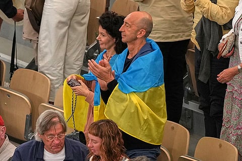 Fans wear Ukranina flags after the quarterfinal tennis match between Ukraine's Elina Svitolina and Ukraine's Marta Kostyuk at the French Open in Paris.