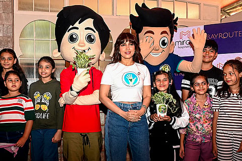 Bollywood actor Bhumi Pednekar poses with Nickelodeon India's animated characters Chikoo and Bunty during an event ahead of World Environment Day, in Mumbai.