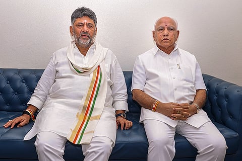 Karnataka Chief Minister-designate DK Shivakumar with former state chief minister BS Yediyurappa before the swearing-in ceremony of the new state government, in Bengaluru.