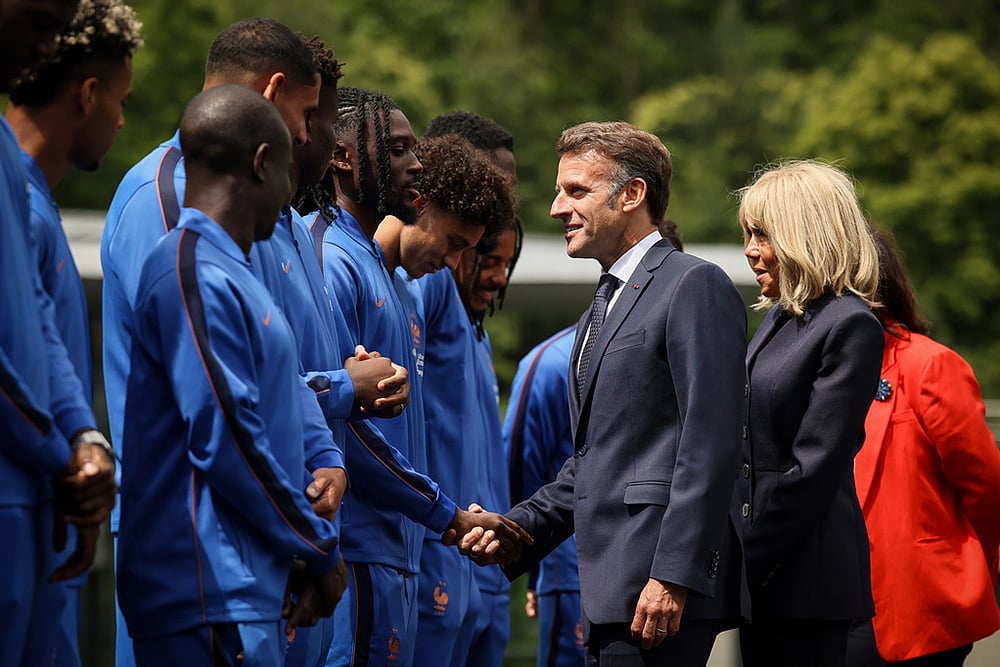 French President Emmanuel Macron and his wife Brigitte Macron meet the French soccer team