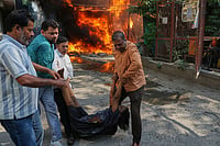 Delhi Hotel Fire: PM Modi Announces Ex-Gratia for Malviya Nagar Victims | Photo: AP/Manish Swarup : Local people rescue a foreign national from a hotel fire in New Delhi, India.