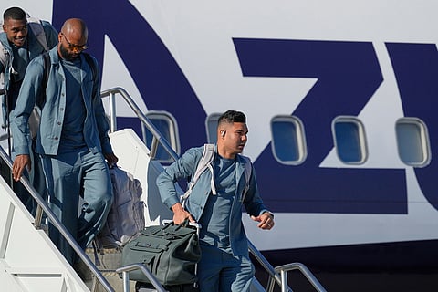 Brazilian soccer player Casemiro, right, and other teammates disembark at Newark Liberty International Airport in Newark, N.J., as the team arrives ahead of the World Cup soccer tournament.