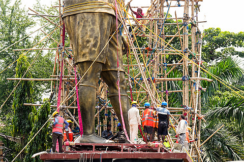 PWD workers use a crane to dismantle a statue of Argentine footballer Lionel Messi, in Kolkata.