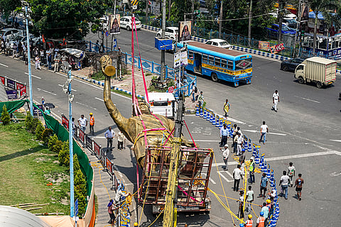 PWD workers shift a statue of Argentine footballer Lionel Messi on a trailer, in Kolkata.