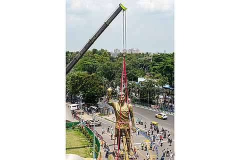 PWD workers use a crane to remove a statue of Argentine footballer Lionel Messi, in Kolkata.