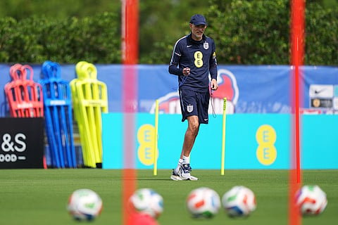 England's head coach Thomas Tuchel walks on the practice pitch ahead of a training session for the national soccer team in Palm Beach Gardens, Fla., ahead of the World Cup soccer tournament.