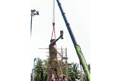 PWD workers use a crane to dismantle a statue of Argentine footballer Lionel Messi, in Kolkata.
