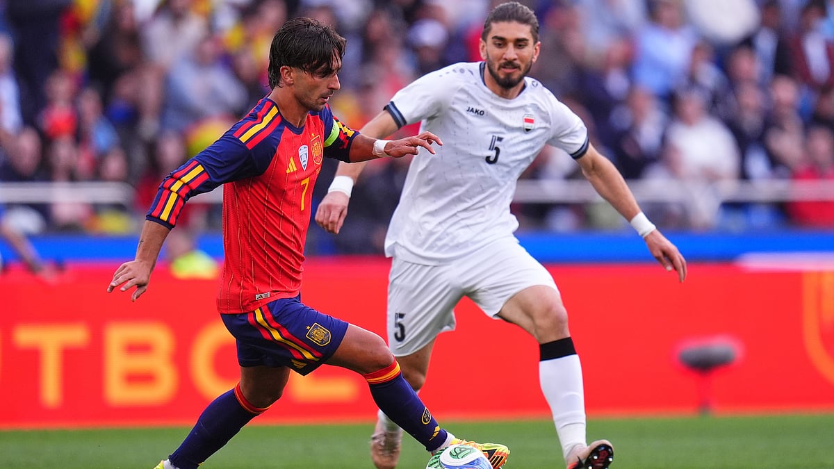 Spain's Ferran Torres, left, runs with the ball next to Iraq's Akam Hashim during an international friendly soccer match in A Coruna, Spain. - AP Photo