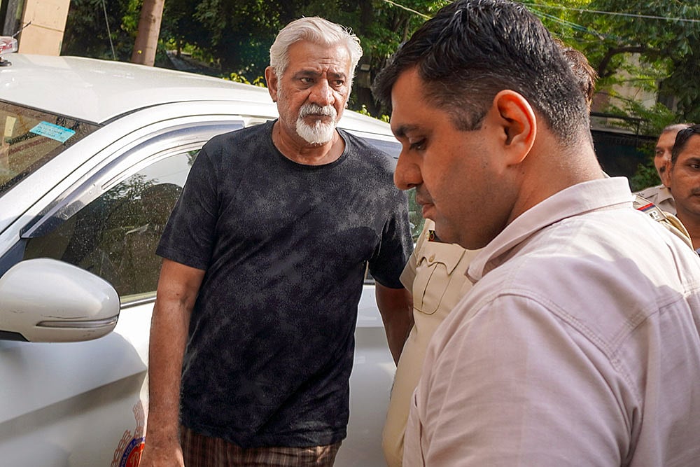 Lokesh Bajaj, owner of the hotel where 21 people were killed in a fire incident on Wednesday, brought to the Malviya Nagar Police Station after the Saket court sent him to four days' police custody, in New Delhi. - | Photo: PTI