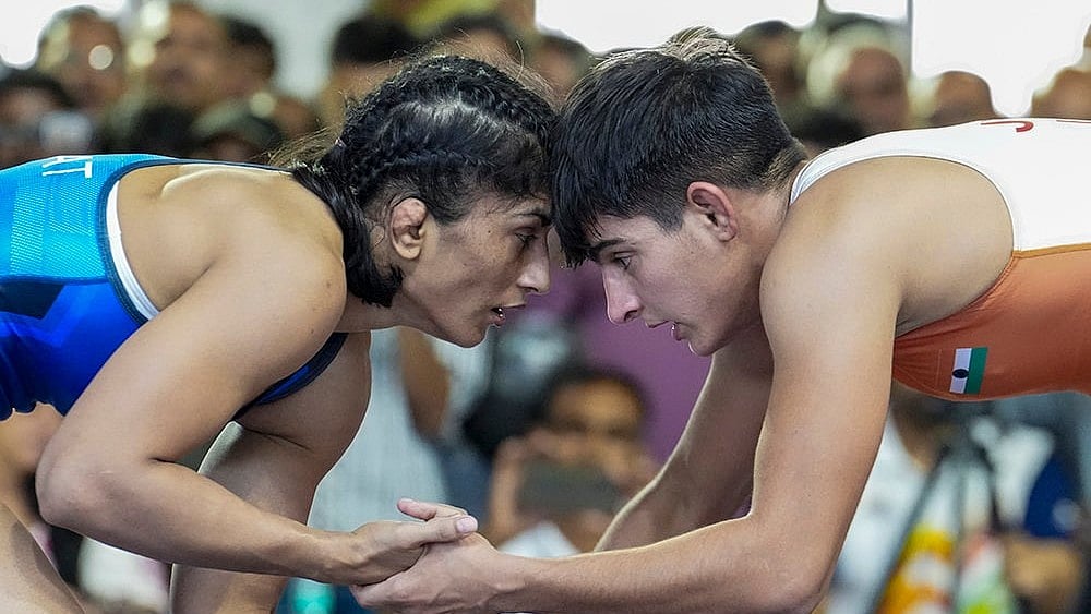 Vinesh Phogat, in blue, competes against Jyoti in a 53kg category wrestling match during the Asian Games selection trials, in New Delhi. - | Photo: PTI/Kamal Kishore