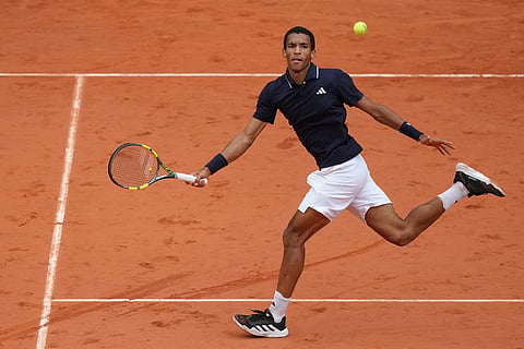 Canada's Felix Auger-Aliassime returns to Italy's Flavio Cobolli during the quarterfinal tennis match at the French Open in Paris