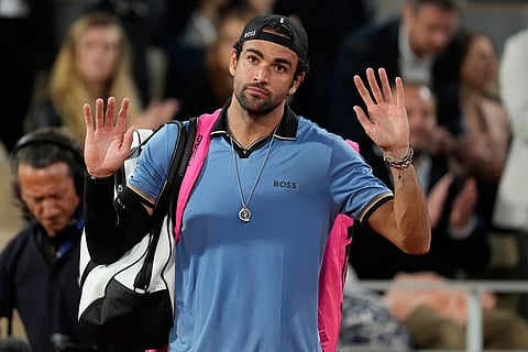Italy's Matteo Berrettini walks off the court because of an injury during the quarterfinal tennis match against Italy's Matteo Arnaldi at the French Open in Paris.