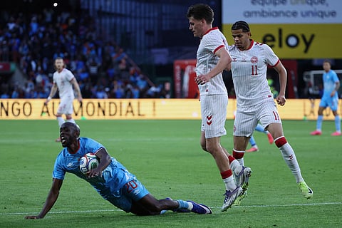 DR Congo's Yoane Wissa falls besides Denmark's Joakim Mahle during the international friendly soccer match between DR Congo and Denmark in Liege, Belgium.