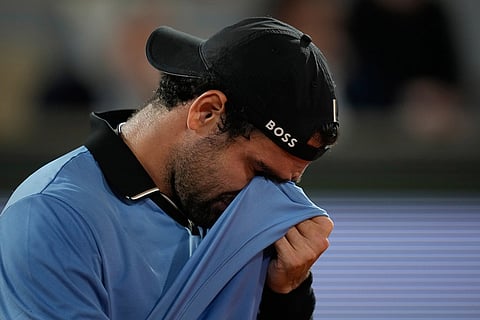 Italy's Matteo Berrettini reacts to an injury during the quarterfinal tennis match gainst Italy's Matteo Arnaldi at the French Open in Paris.