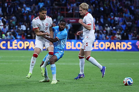 Denmark's William Osula, left, DR Congo's Cedric Bakambu, and Denmark's Joachim Andersen challenge for the ball during the international friendly soccer match between DR Congo and Denmark in Liege, Belgium.