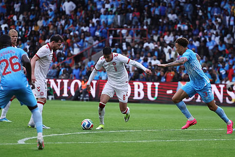 Denmark's Adam Daghim, center controls the ball besides DR Congo's Steve Kapuadi during the international friendly soccer match between DR Congo and Denmark in Liege, Belgium.
