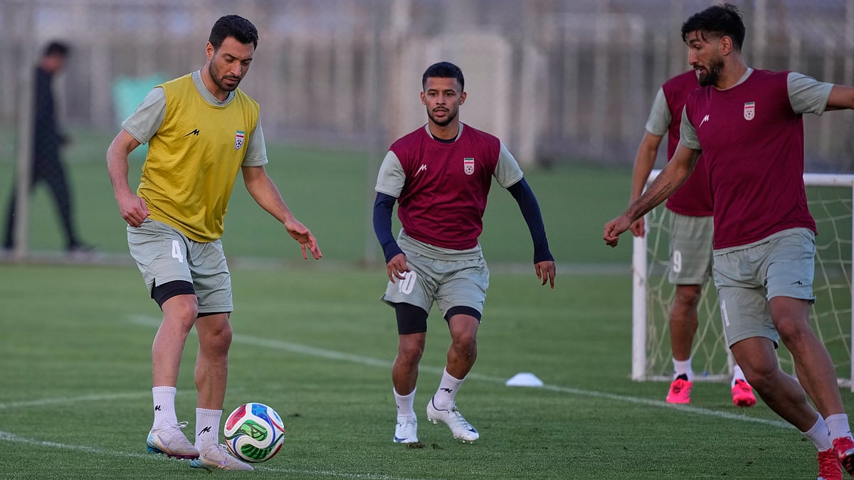 Iran’s Shojae Khalilzadeh, left, plays the ball with teammates during a training session, in Antalya, southern Turkey, ahead of the World Cup soccer tournament. - AP Photo