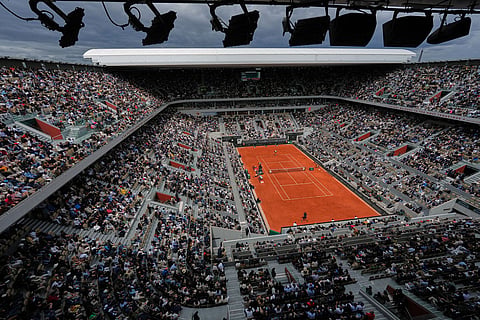 Fans watch the semifinal tennis match between Czech Republic's Jakub Mensik and Germany's Alexander Zverev at the French Open in Paris.