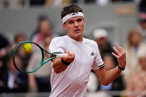Czech Republic's Jakub Mensik returns to Germany's Alexander Zverev during the semifinal tennis match at the French Open in Paris.