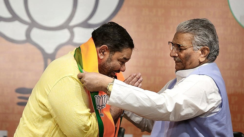 Odisha BJP in-charge Vijaypal Singh Tomar felicitates former BJD MP Debashish Samantaray after the latter joins BJP during a press conference, at the party headquarters, in New Delhi. - Photo: PTI