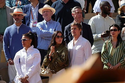 Brad Pitt, centre right, and Ines de Ramon, centre left, stand at the end of the final women's tennis match between Poland's Maja Chwalinska and Russia's Mirra Andreeva at the French Open in Paris.