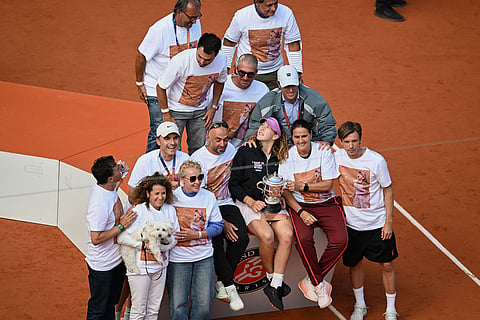 Russia's Mirra Andreeva poses with her team after winning the final tennis match against Poland's Maja Chwalinska at the French Open in Paris.