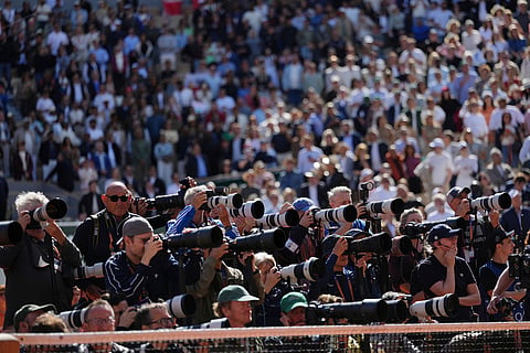 Photographers cover the award ceremony for the final women's tennis match between Poland's Maja Chwalinska and Russia's Mirra Andreeva at the French Open in Paris.