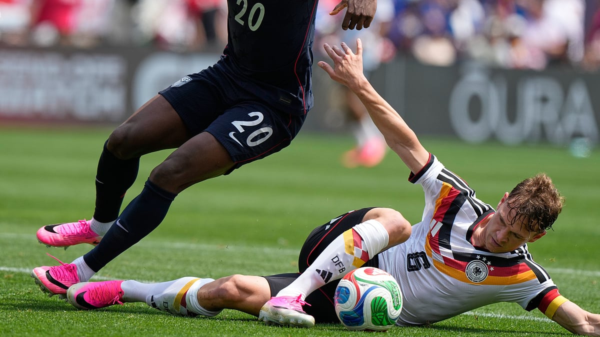 Germany midfielder Joshua Kimmich, right, controls the ball under United States forward Folarin Balogun during the first half of an international friendly soccer match in Chicago. - AP Photo