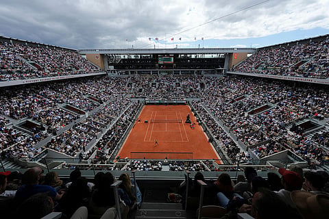 Poland's Maja Chwalinska, bottom, returns during the final tennis match against Russia's Mirra Andreeva at the French Open in Paris.