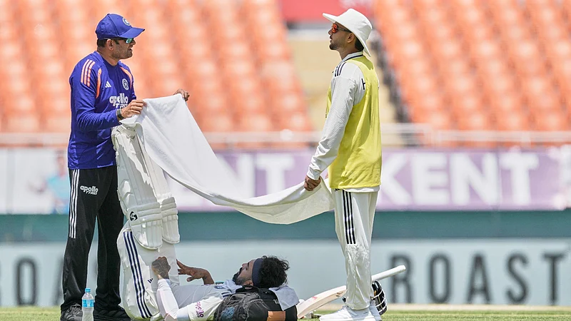 AP Photo/Ashwini Bhatia) : Indias KL Rahul seeks respite from the mid-day heat during a drinks break on day one of the cricket test match between Afghanistan and India in New Chandigarh, India, Saturday, June 6, 2026.