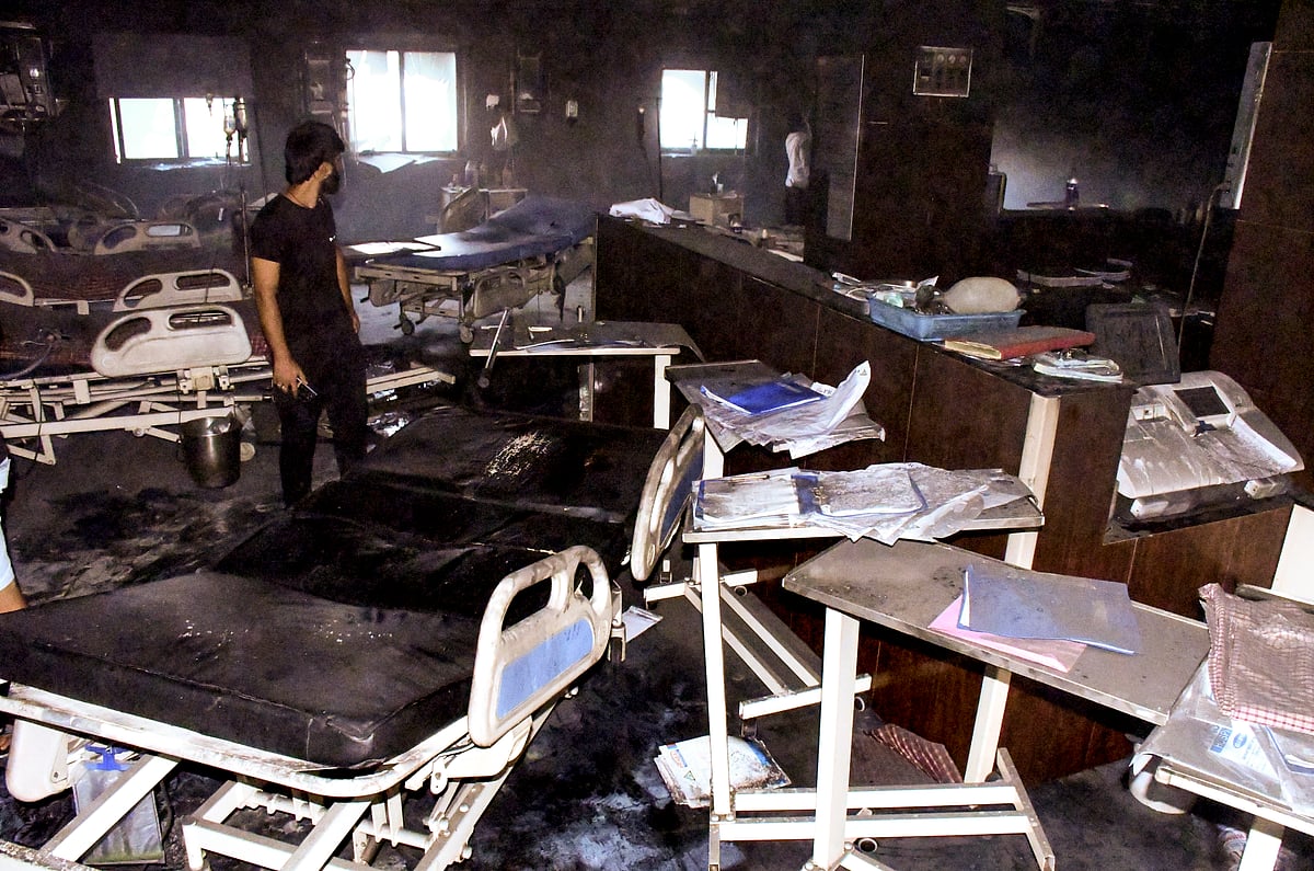 A man looks at the charred remains after a fire broke out in the ICU of a private hospital in Bihar's Muzaffarpur district, Thursday, June 4, 2026. The death toll has risen to 7.  - (PTI Photo) 