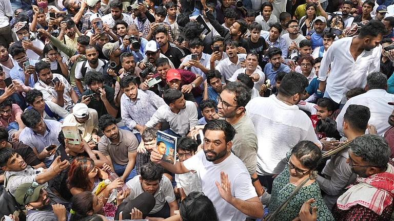 Abhijeet Dipke at the protest holding the autobiography of BR Ambedkar. - Suresh K Pandey