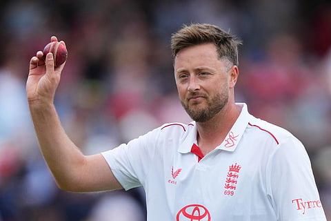 England's Ollie Robinson holds up the match ball after New Zealand are out for 113 during the second day of the test match between England and New Zealand at Lord's cricket ground in London.