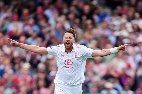England's Ollie Robinson celebrates taking his fifth wicket, the wicket of New Zealand's Matt Henry during the second day of the test match between England and New Zealand at Lord's cricket ground in London.