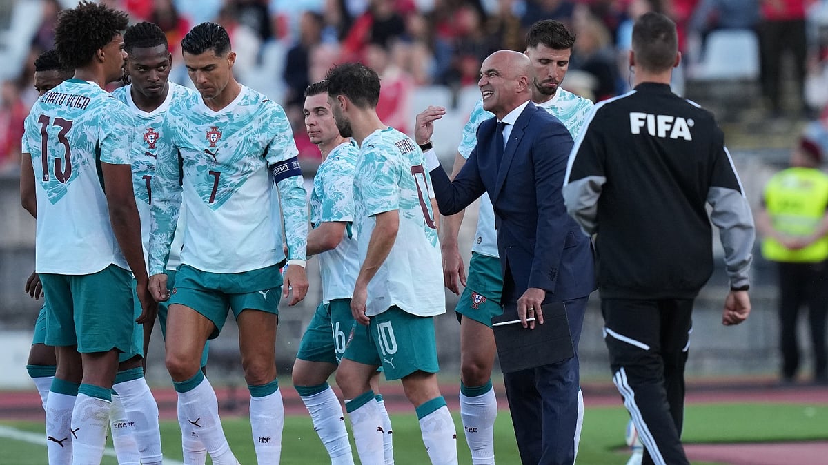 Portugal coach Roberto Martinez instructs his players during an international friendly soccer match between Portugal and Chile in Oeiras, outside Lisbon. - AP Photo
