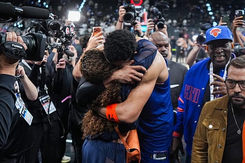 New York Knicks center Karl-Anthony Towns is embraces as he leaves the court after Game 2 of the NBA Finals basketball series against the San Antonio Spurs in San Antonio.