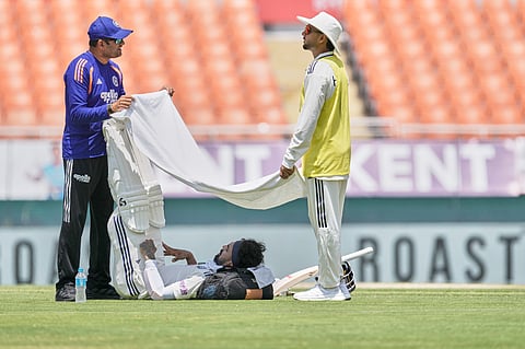 India's KL Rahul seeks respite from the mid-day heat during a drinks break on day one of the cricket test match between Afghanistan and India in New Chandigarh, India, Saturday, June 6, 2026. 