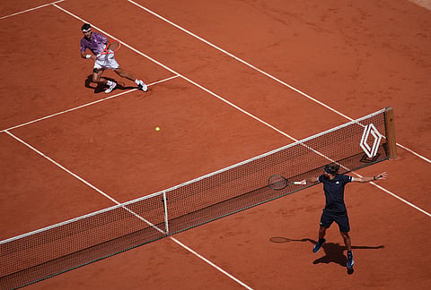 Alexander Zverev of Germany, right, returns to Flavio Cobolli of Italy during their men's final match at the French Open tennis tournament in Paris.