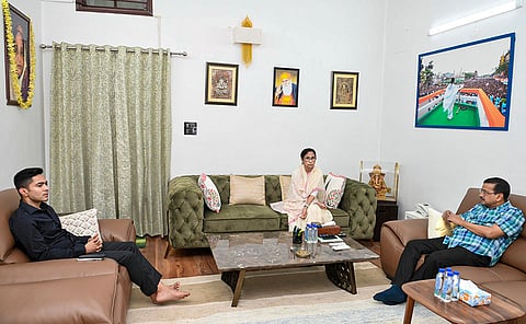 TMC supremo Mamata Banerjee interacts with AAP National Convenor Arvind Kejriwal, right, and TMC leader Abhishek Banerjee, left, in New Delhi. 