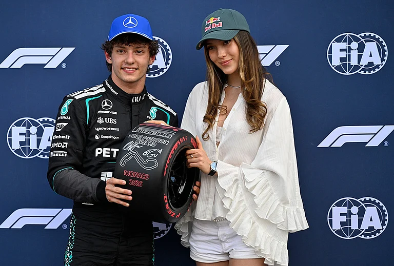Mercedes driver Andrea Kimi Antonelli of Italy, poses with Eileen Gu after setting the pole position in the qualifying session for the Monaco F1 Grand Prix, at the Monaco racetrack. - | Photo: AP/Philippe Magoni