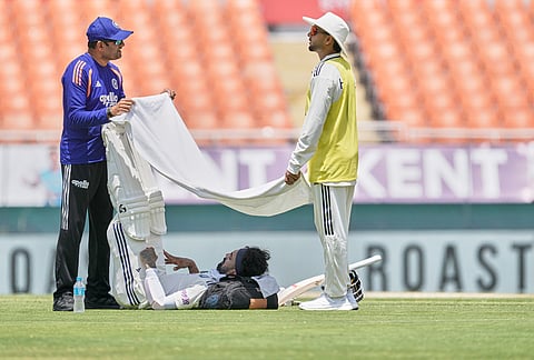 India's KL Rahul seeks respite from the mid-day heat during a drinks break on day one of the cricket test match between Afghanistan and India in New Chandigarh.