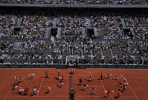 Dancers perform before the final tennis match between Germany's Alexander Zverev and Italy's Flavio Cobolli at the French Open in Paris. 