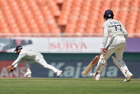 Afghanistan's captain Hashmatullah Shahidi dives to field a shot from India's captain Shubman Gill, right, on day one of the cricket test match between Afghanistan and India in New Chandigarh.