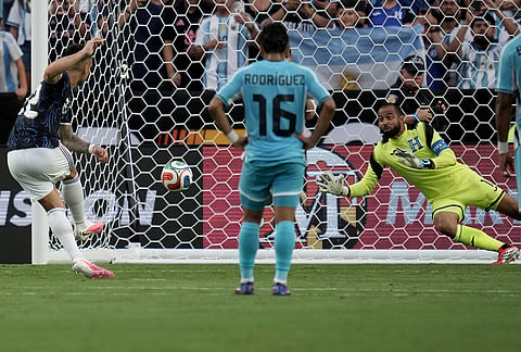 Argentina forward Lautaro Martínez, left, scores on a penalty kick as Honduras goalie Edrick Menjivar (1) dives to try and block it during the first half of an international friendly soccer match in College Station, Texas. 
