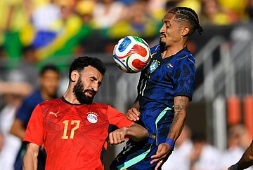 | Photo: AP/David Richard : Egypt's Mohanad Lasheen (17) attempts to head the ball beside Brazil's Raphinha (11) during an international friendly soccer match in Cleveland.