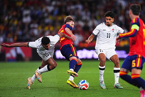 Spain's Jesús Rodriguez, center, duel for the ball with Iraq's Ahmed Yahya Mhmood Al-Hajjaj, left, and Ahmed Qasem during an international friendly soccer match in A Coruna, Spain.