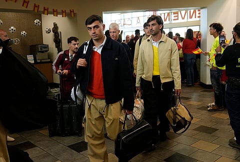 Spain midfielder Pedri, left, arrives with teammates for the World Cup soccer tournament in Chattanooga, Tennessee.