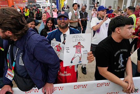 Fans look on as the Swedish men's national team board a waiting bus after arriving at Dallas Fort Worth International Airport, in DFW Airport, Texas, ahead of the World Cup soccer tournament. 